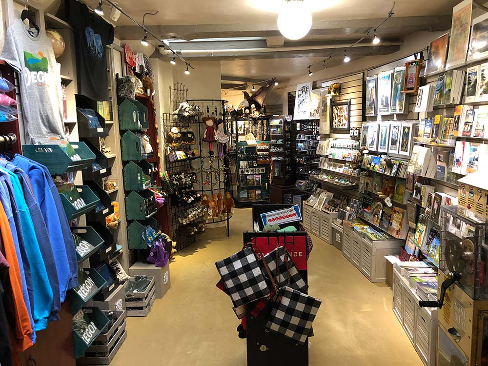 Image of the gift shop in the Vista House, showing sweatshirts, art prints, and other trinkets.