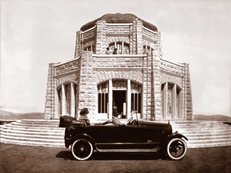 Antique image of the the Vista House, with a vintage car parked directly in front.