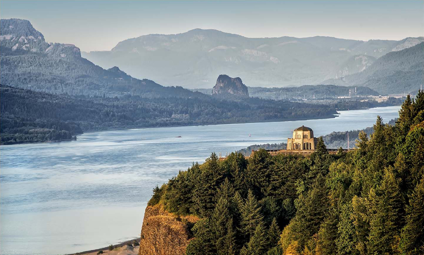 Far-away shot of the Vista House and the Columbia River Gorge.